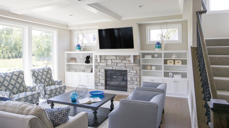 TV over fireplace in open concept floor plan 